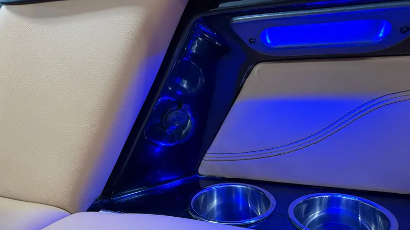 Slide: The Image of Interior of a 2019 MasterCraft XT22 with blue lighting and cup holders. - 27