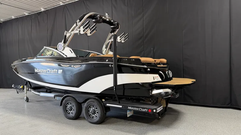 Slide: The Image of A black 2019 MasterCraft XT22 boat on a trailer in an indoor setting. - 3