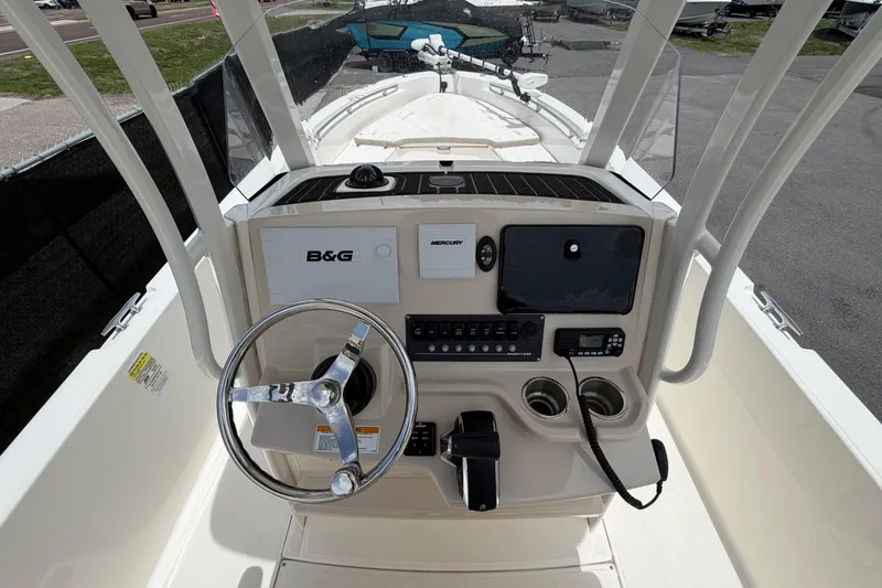 Slide: The Image of 2022 Boston Whaler 250 Dauntless boat console with steering wheel and navigation controls. - 19