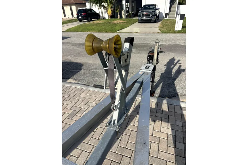 Slide: The Image of Boat trailer for 2022 Boston Whaler 250 Dauntless on paved driveway. - 35