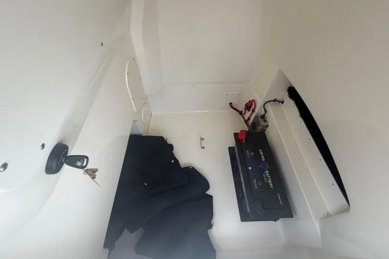 Slide: The Image of Interior of a 2022 Boston Whaler 250 Dauntless showing battery compartment and keys. - 48