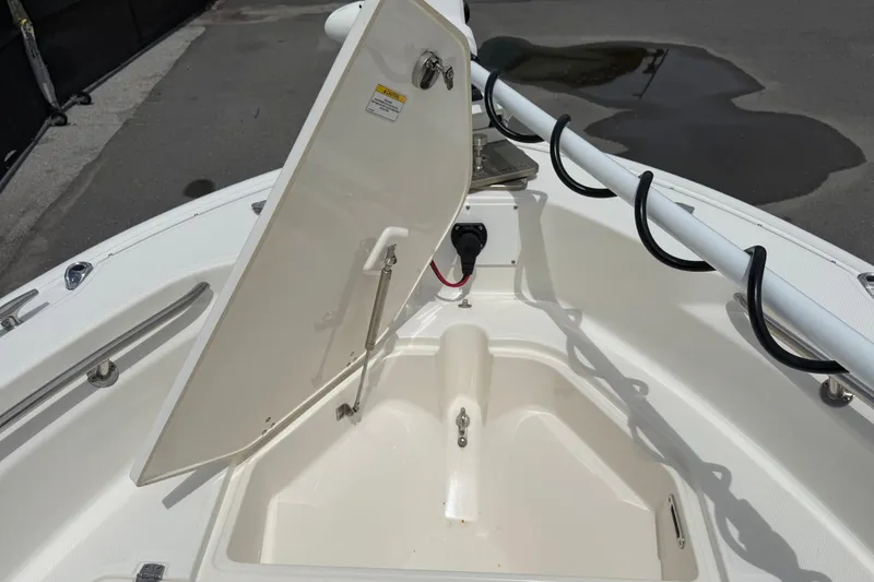 Slide: The Image of The image shows the bow of a 2022 Boston Whaler 250 Dauntless with an open storage compartment. - 33
