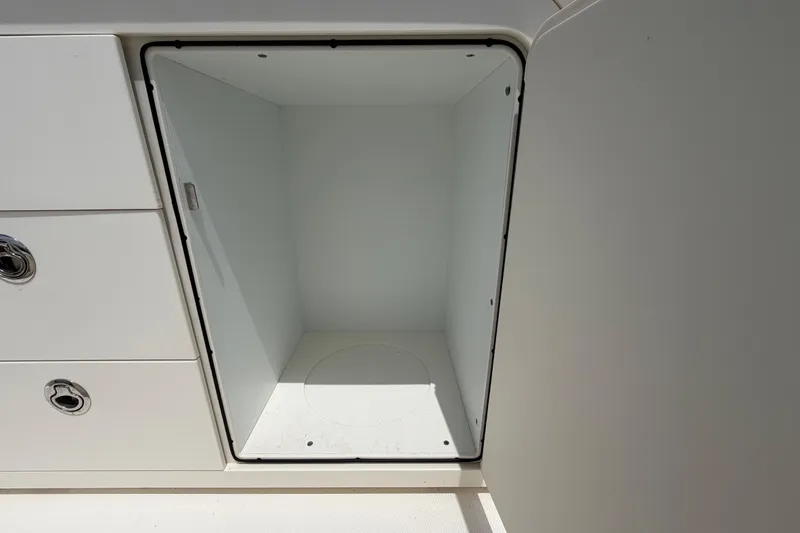 Slide: The Image of Storage compartment on a 2022 Boston Whaler 250 Dauntless boat, open and empty. - 15