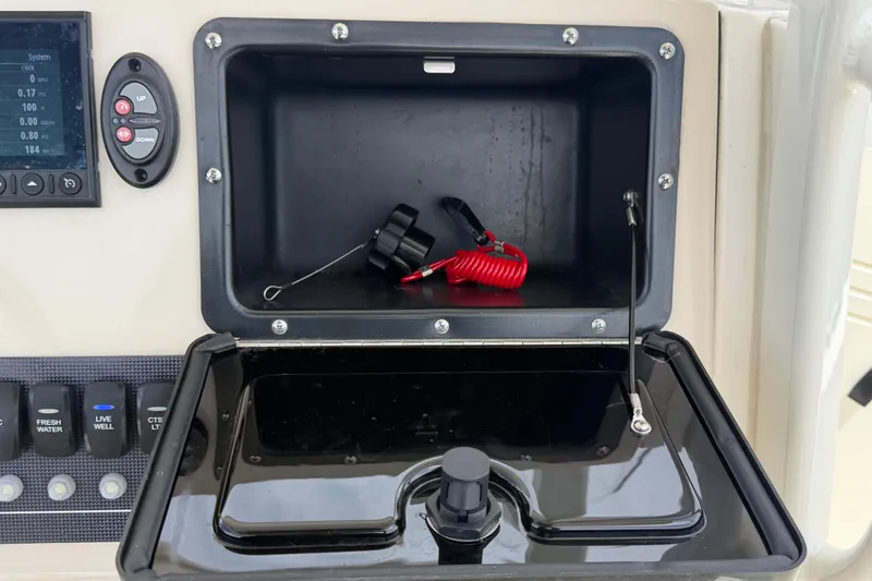 Slide: The Image of Control panel and storage compartment on a 2022 Boston Whaler 250 Dauntless boat. - 25