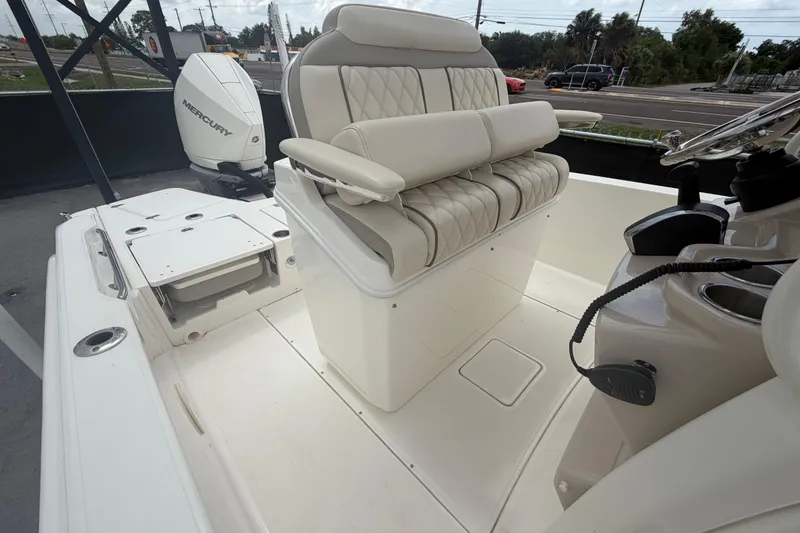 Slide: The Image of 2022 Boston Whaler 250 Dauntless boat interior with cushioned seating and Mercury engine. - 50