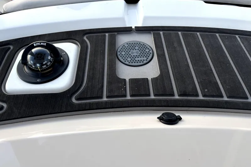 Slide: The Image of 2022 Boston Whaler 250 Dauntless dashboard with compass and speaker detail. - 28