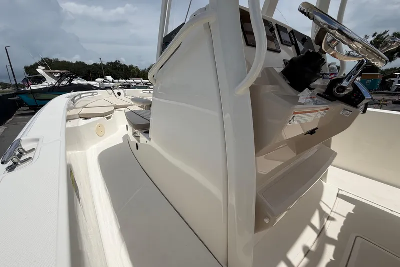 Slide: The Image of 2022 Boston Whaler 250 Dauntless boat interior with steering console and seating area. - 27