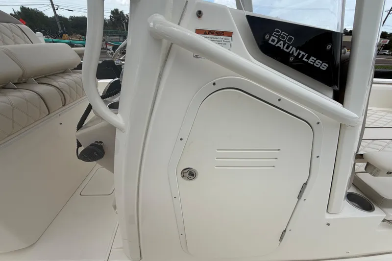 Slide: The Image of 2022 Boston Whaler 250 Dauntless boat interior, featuring seating and storage compartment. - 46