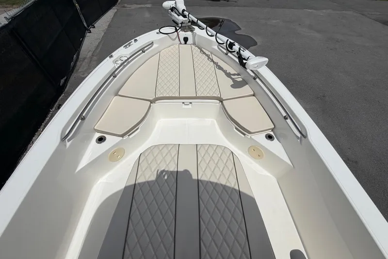 Slide: The Image of 2022 Boston Whaler 250 Dauntless boat interior with cushioned seating and sleek design. - 28