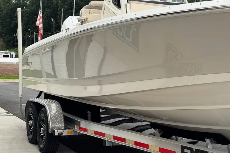 Slide: The Image of 2022 Boston Whaler 250 Dauntless boat on trailer, side view with American flag. - 7