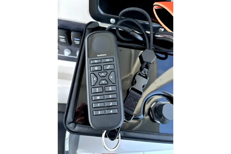 Slide: The Image of Garmin remote control on a 2022 Boston Whaler 250 Dauntless boat dashboard. - 43
