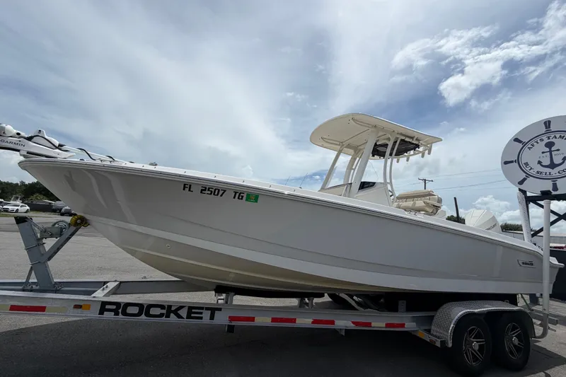 Slide: The Image of 2022 Boston Whaler 250 Dauntless boat on trailer, displayed outdoors under cloudy sky. - 8