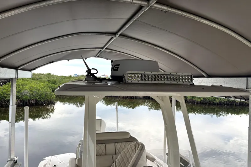 Slide: The Image of 2022 Boston Whaler 250 Dauntless under canopy, featuring radar and LED light bar. - 23