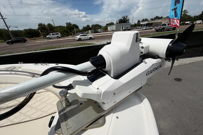 Slide: The Image of 2022 Boston Whaler 250 Dauntless with Garmin trolling motor, parked near a busy road. - 35