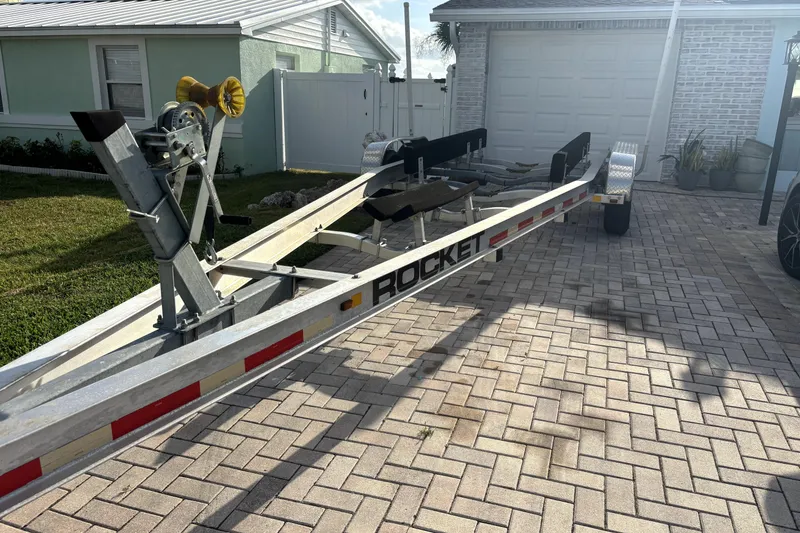 Slide: The Image of Boat trailer for 2022 Boston Whaler 250 Dauntless on brick driveway. - 34