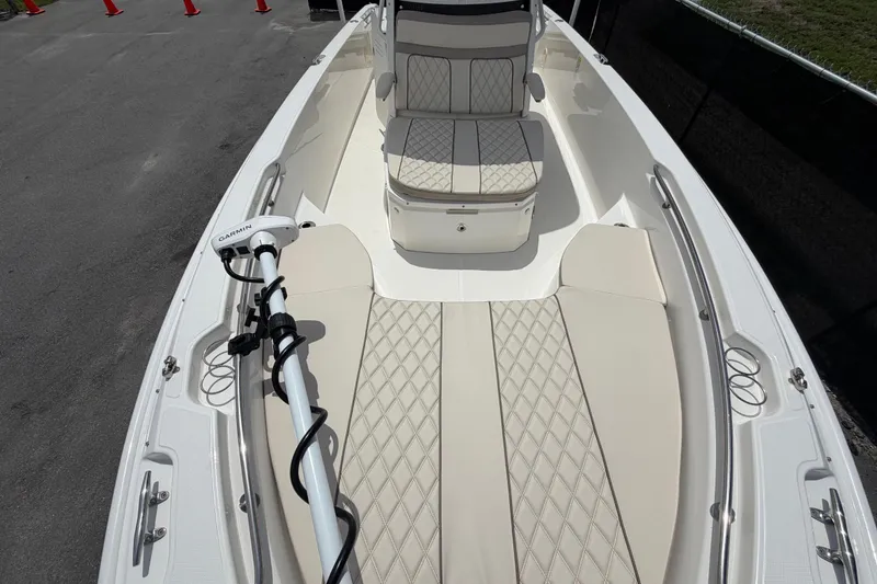 Slide: The Image of 2022 Boston Whaler 250 Dauntless boat interior with cushioned seating and Garmin equipment. - 38