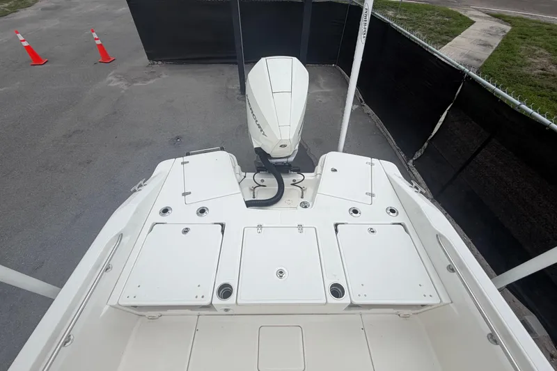 Slide: The Image of 2022 Boston Whaler 250 Dauntless boat with Mercury engine, docked on pavement. - 52