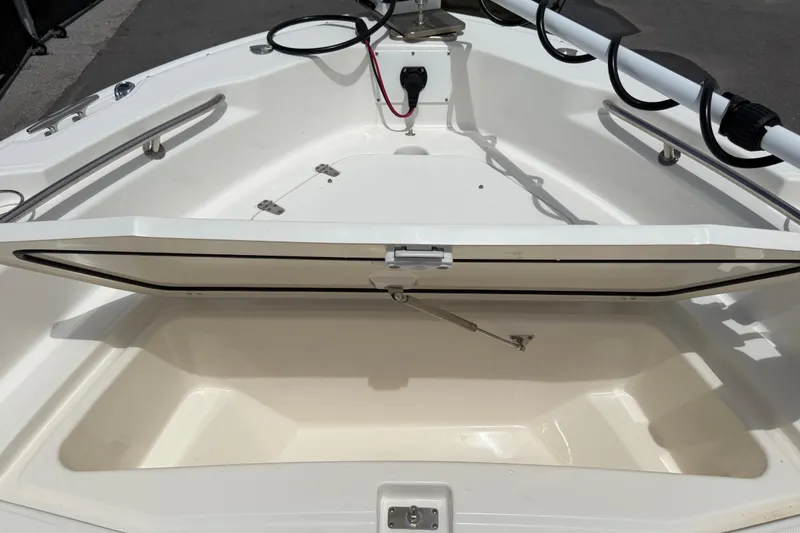 Slide: The Image of 2022 Boston Whaler 250 Dauntless boat storage compartment open, showcasing spacious interior. - 31