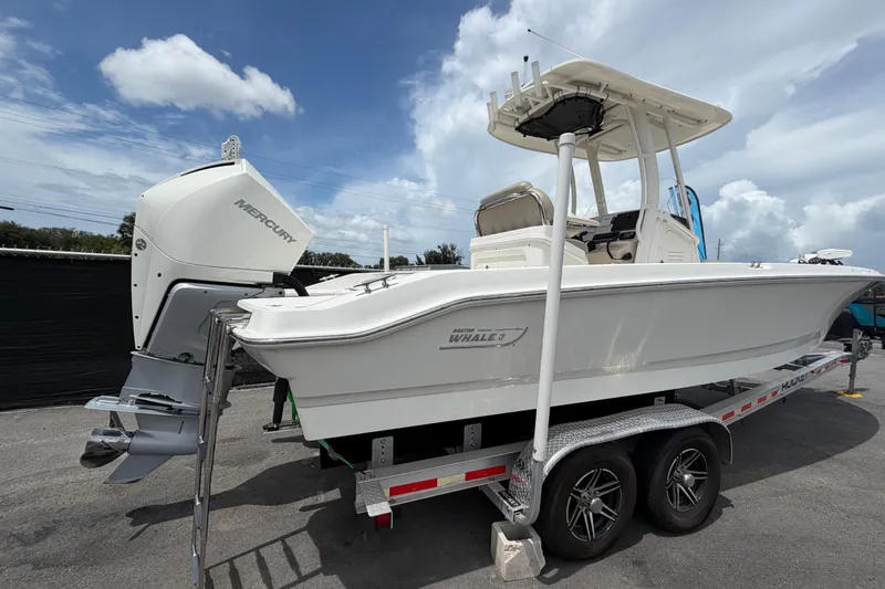 Slide: The Image of 2022 Boston Whaler 250 Dauntless boat on trailer, featuring Mercury outboard engine. - 2
