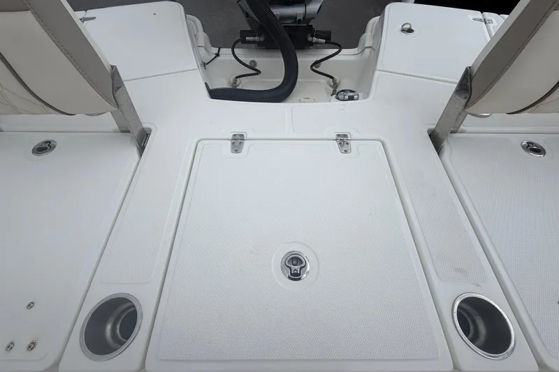 Slide: The Image of 2022 Boston Whaler 250 Dauntless boat deck with storage compartments and cup holders. - 55