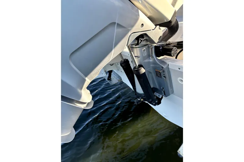 Slide: The Image of 2022 Boston Whaler 250 Dauntless outboard motor detail over water. - 42