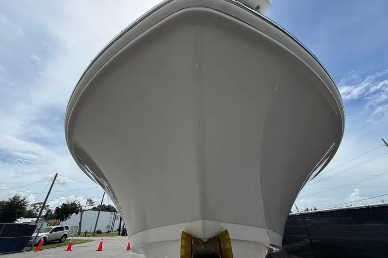 Slide: The Image of 2022 Boston Whaler 250 Dauntless boat, front view, under clear sky. - 10
