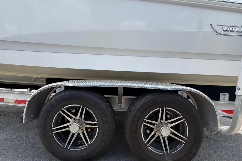 Slide: The Image of 2022 Boston Whaler 250 Dauntless boat on trailer with dual wheels. - 65
