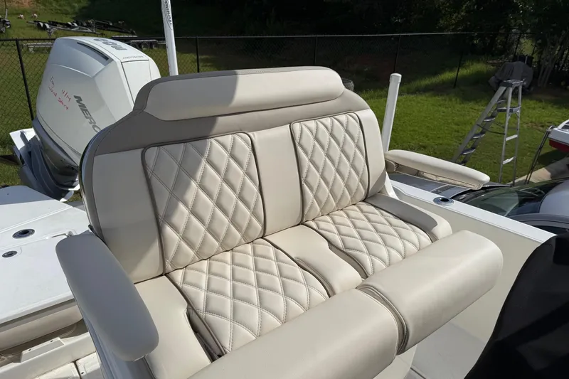 Slide: The Image of Luxurious seating on a 2022 Boston Whaler 250 Dauntless boat, featuring diamond-stitched upholstery. - 11