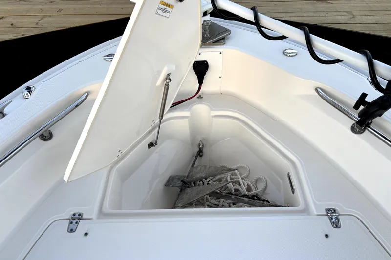 Slide: The Image of Open anchor storage on 2022 Boston Whaler 250 Dauntless boat, showcasing ropes and anchor. - 32