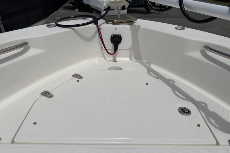 Slide: The Image of 2022 Boston Whaler 250 Dauntless boat deck with storage compartment and wiring. - 32