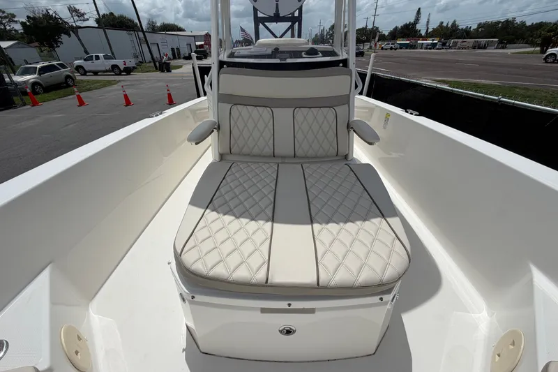 Slide: The Image of 2022 Boston Whaler 250 Dauntless boat interior with cushioned seating and armrests. - 41
