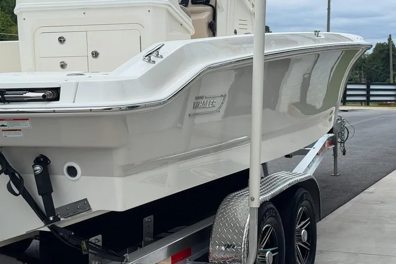 Slide: The Image of 2022 Boston Whaler 250 Dauntless boat on trailer, showcasing sleek design and modern features. - 6