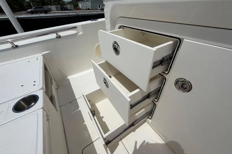 Slide: The Image of Storage drawers on a 2022 Boston Whaler 250 Dauntless boat, showcasing ample onboard organization. - 16