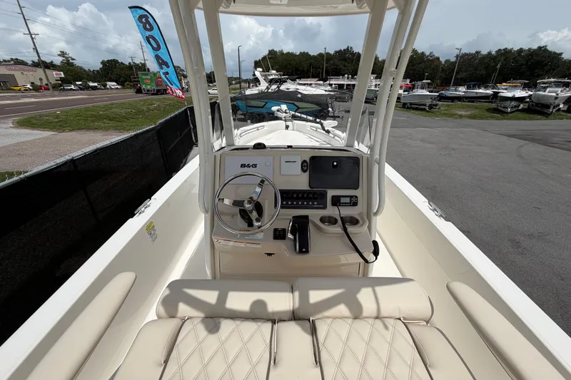 Slide: The Image of 2022 Boston Whaler 250 Dauntless boat interior with steering console and seating. - 18