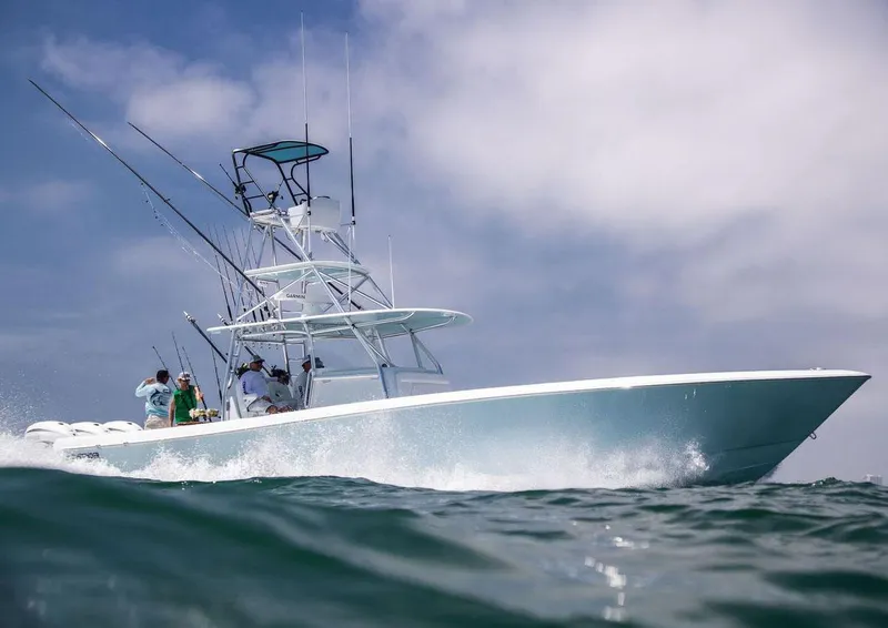Slide: The Image of Manufacturer Provided Image: 2026 Contender 44 CB boat cruising on open water. - 4