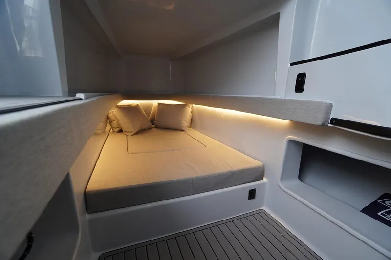 Slide: The Image of Manufacturer Provided Image: 2026 Contender 44 CB cabin interior with cozy bed and ambient lighting. - 11