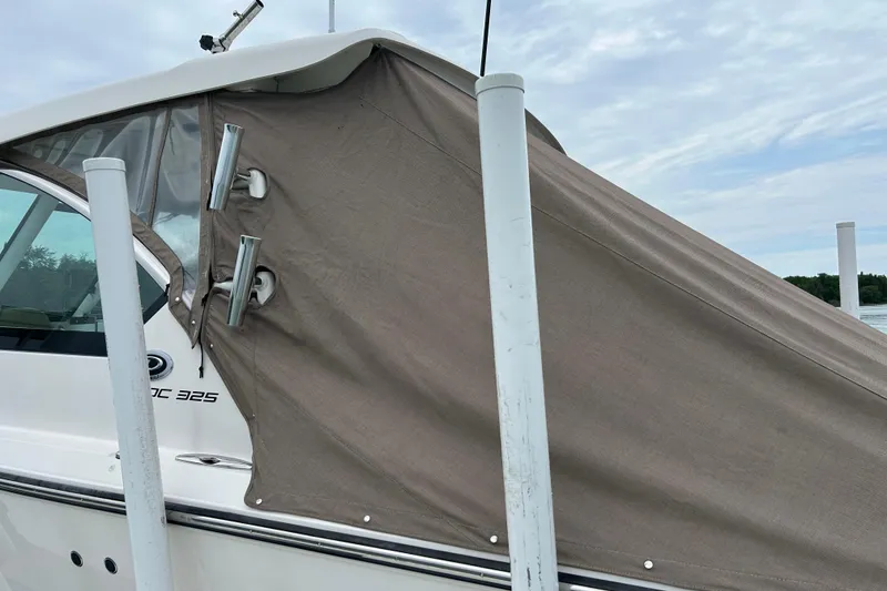 Slide: The Image of 2018 Pursuit DC 325 Dual Console boat with protective cover docked. - 20