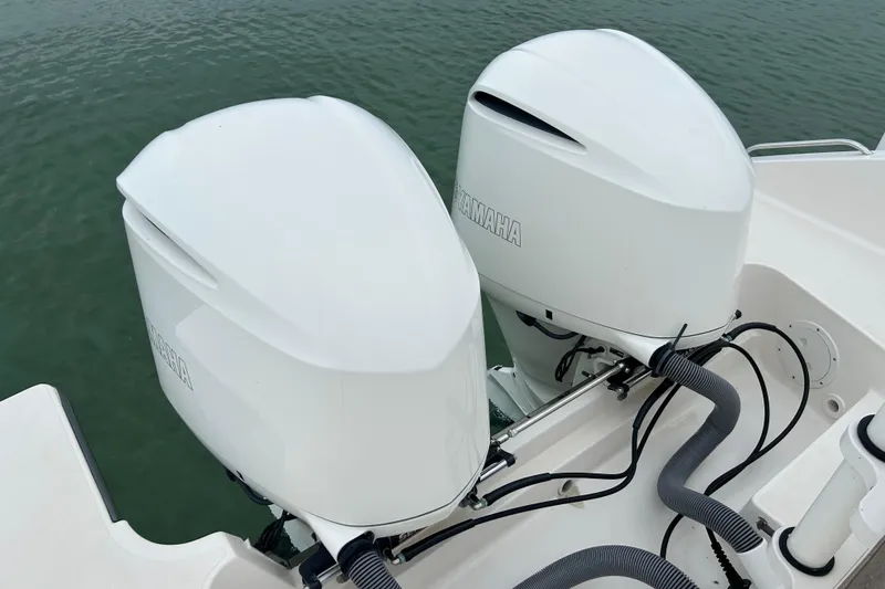 Slide: The Image of 2018 Pursuit DC 325 Dual Console with twin Yamaha outboard engines on water. - 3