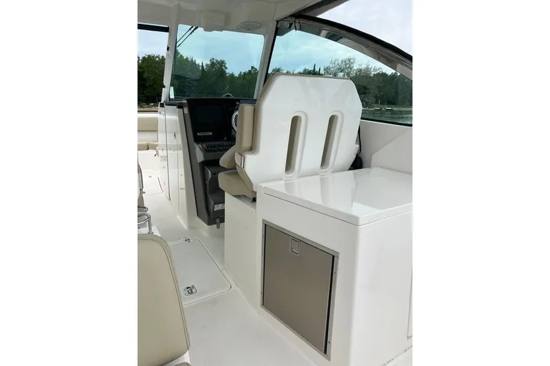 Slide: The Image of 2018 Pursuit DC 325 Dual Console interior with helm and seating area. - 7