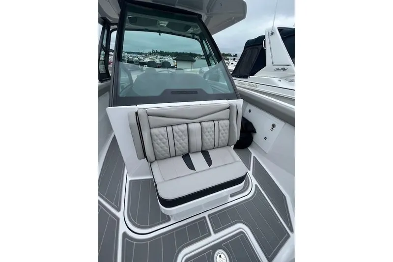 Slide: The Image of 2027 Monterey Elite 30 OB boat interior with cushioned seating and sleek design. - 13