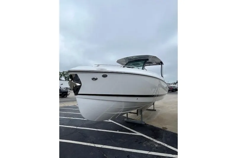 Slide: The Image of 2027 Monterey Elite 30 OB boat displayed on a stand, showcasing sleek design and modern features. - 15