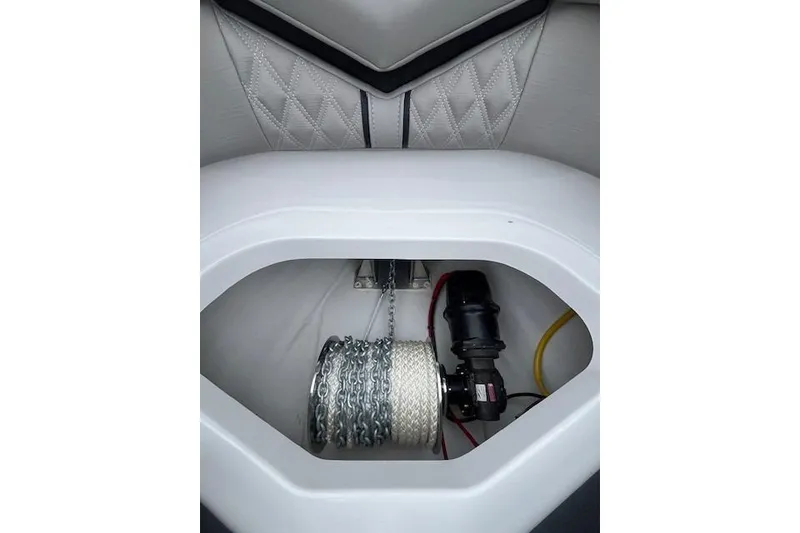 Slide: The Image of Anchor storage compartment in 2027 Monterey Elite 30 OB boat, featuring chain and rope. - 16