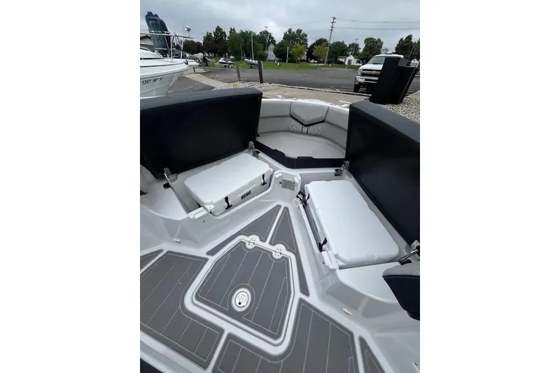 Slide: The Image of 2027 Monterey Elite 30 OB boat interior with cushioned seating and storage compartments. - 18