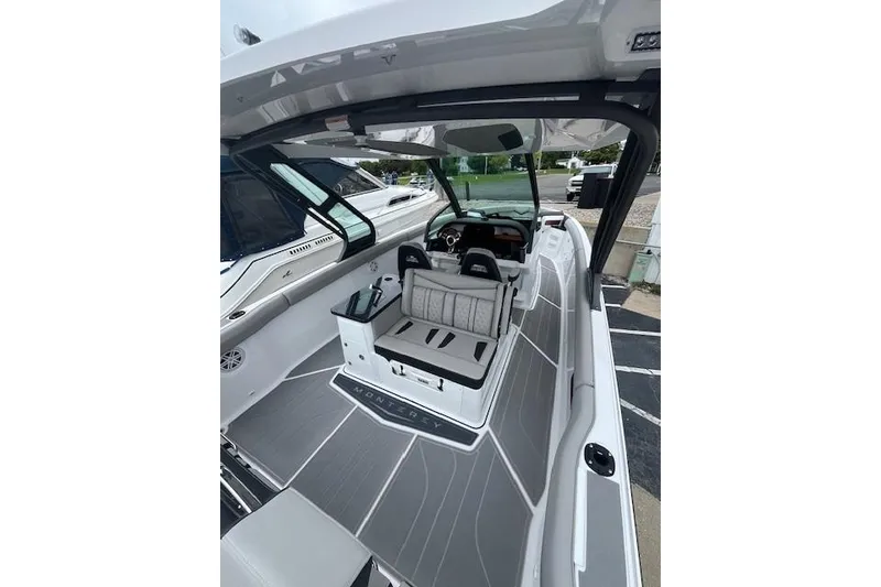 Slide: The Image of 2027 Monterey Elite 30 OB boat interior with sleek seating and modern dashboard design. - 14