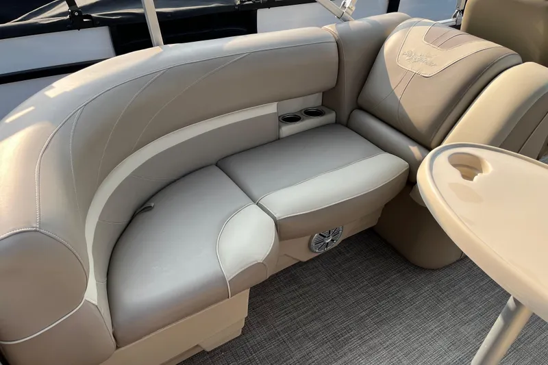 Slide: The Image of Luxurious seating on 2019 SunChaser Geneva Cruise 20 LR pontoon boat with cup holders and table. - 5