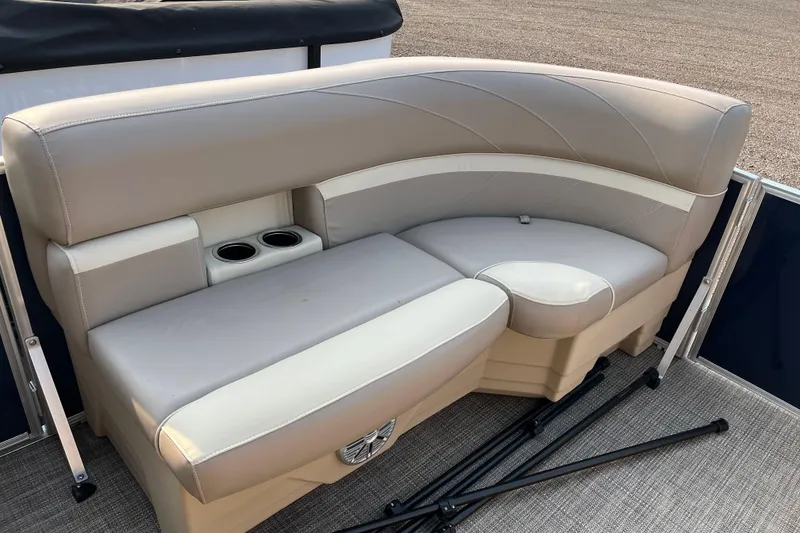 Slide: The Image of 2019 SunChaser Geneva Cruise 20 LR boat seating with cup holders and beige upholstery. - 12