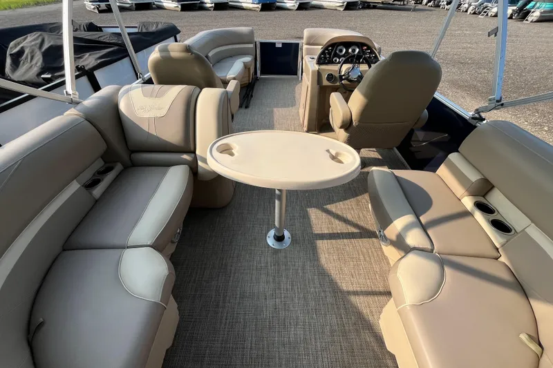 Slide: The Image of Interior of 2019 SunChaser Geneva Cruise 20 LR pontoon boat with beige seating and table. - 4