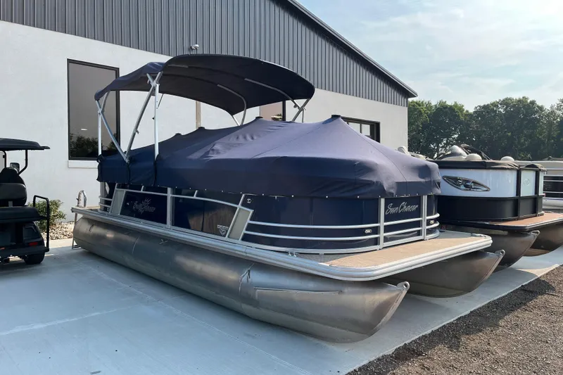 Slide: The Image of 2019 SunChaser Geneva Cruise 20 LR pontoon boat with blue cover, parked outdoors. - 3