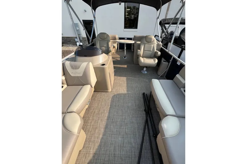 Slide: The Image of 2019 SunChaser Geneva Cruise 20 LR pontoon boat interior with beige seating and canopy. - 13