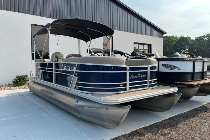 The Image of 2019 SunChaser Geneva Cruise 20 LR pontoon boat parked outdoors. - 0